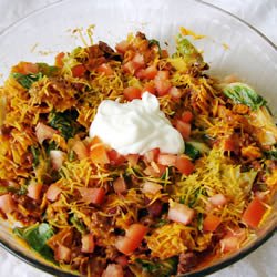 This Easy Taco Salad is the perfect combination of savory and crunch. It is perfect to take to summer picnics and is so simple to whip up! #womenLivingWell #salads #taco #mexican